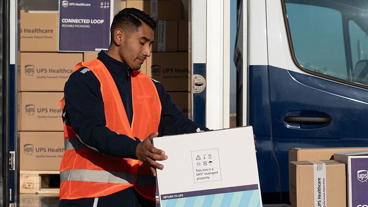 Graphic of worker handing a UPS package outside of truck
